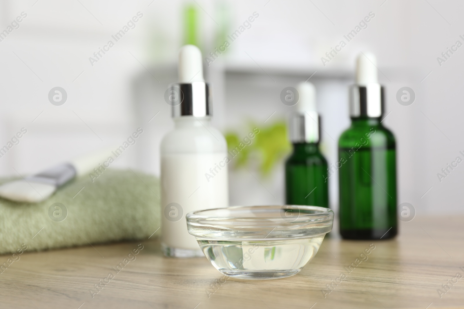 Photo of Peeling procedure. Bottles of chemical peel and bowl with liquid on wooden table indoors