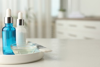 Peeling procedure. Bottles of chemical peel, bowl with liquid and brush on white table indoors. Space for text