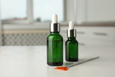 Photo of Peeling procedure. Bottles of chemical peel and brush on white table indoors