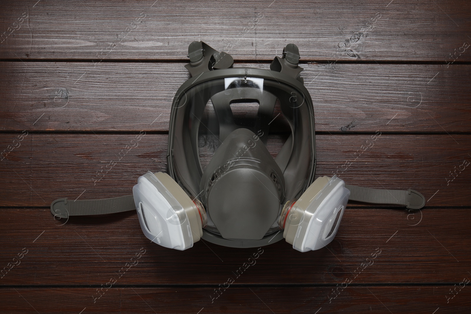 Photo of One respirator mask on wooden table, top view