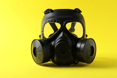 Photo of One gas mask on yellow background. Safety equipment