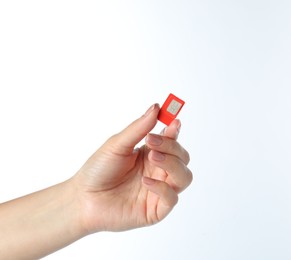 Photo of Woman with SIM card on white background, closeup