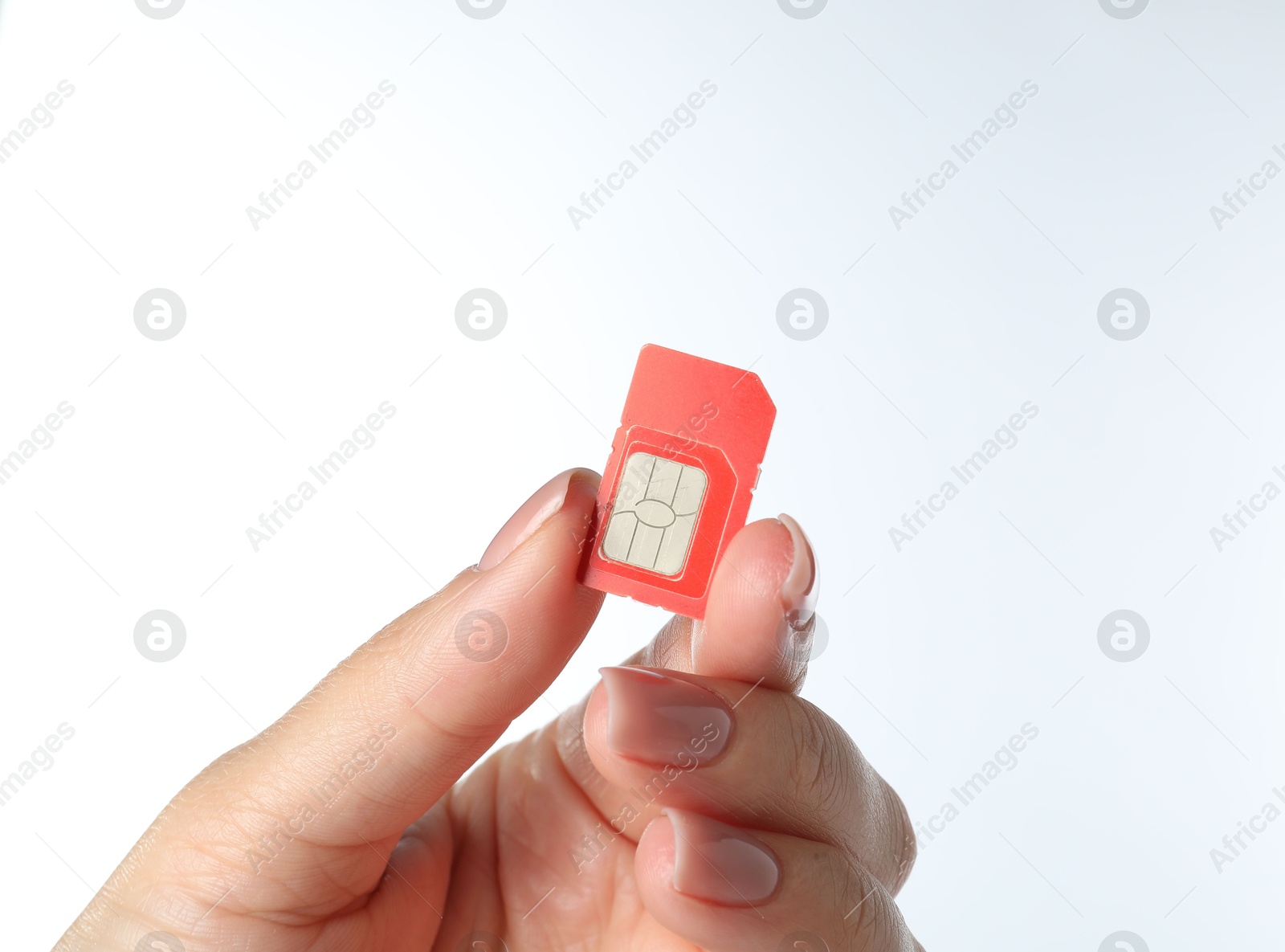 Photo of Woman with SIM card on white background, closeup