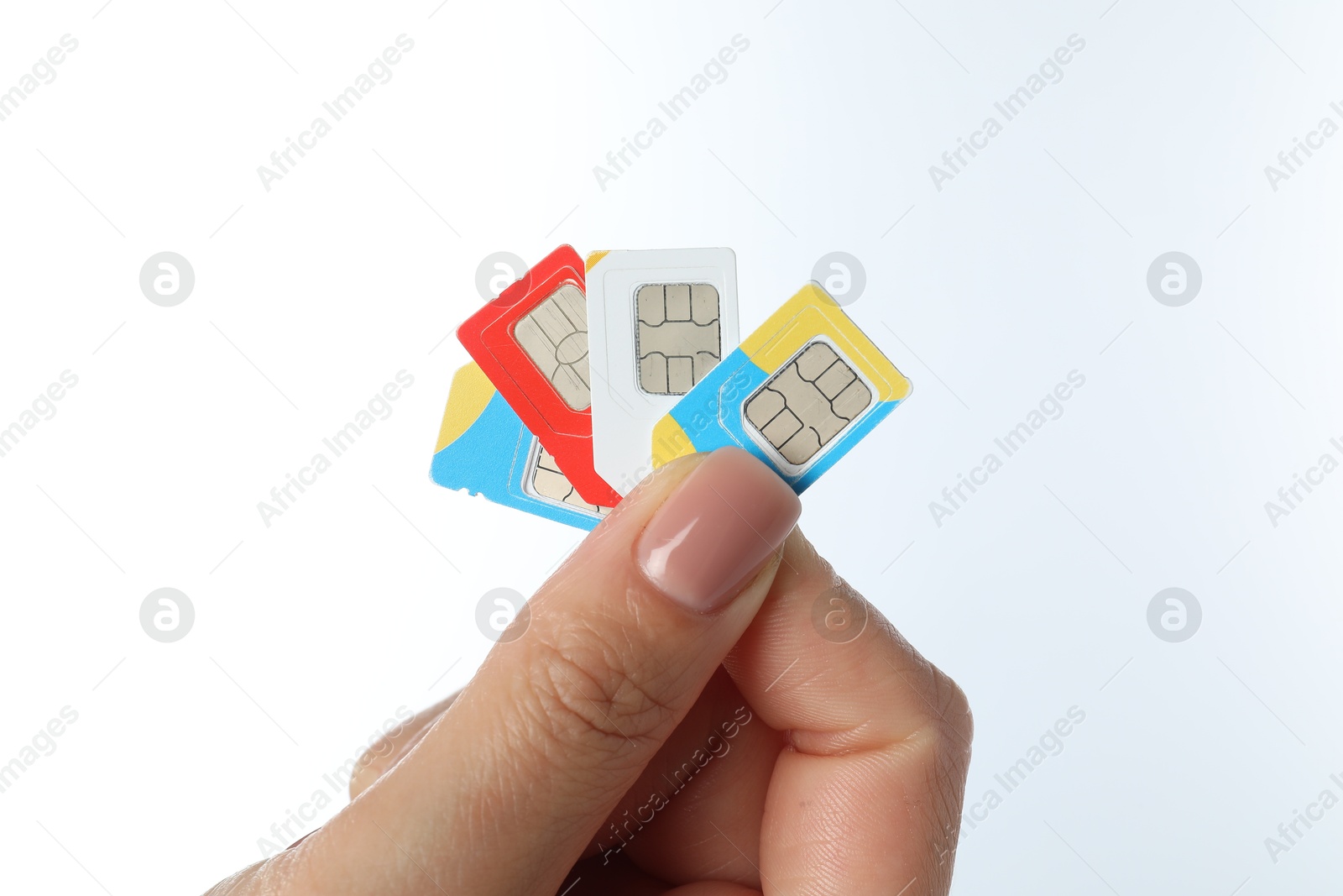 Photo of Woman with SIM cards on white background, closeup