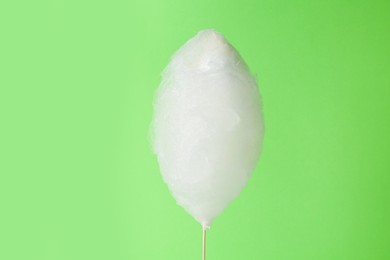 Photo of One sweet cotton candy on light green background