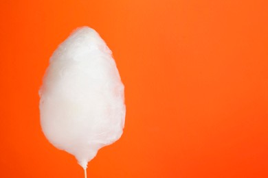 Photo of One sweet cotton candy on orange background. Space for text