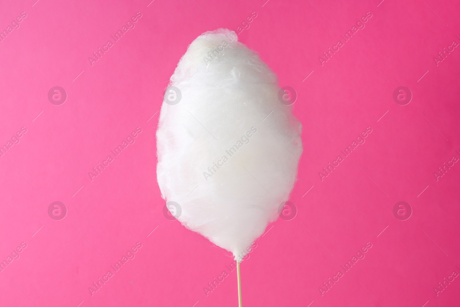 Photo of One sweet cotton candy on pink background