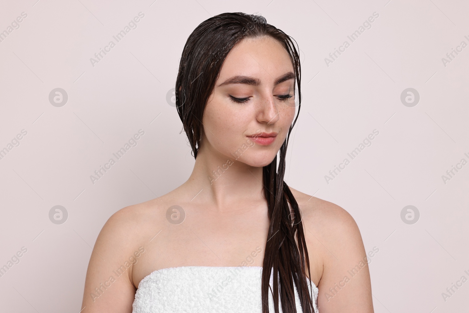 Photo of Beautiful woman with applied hair mask on light background