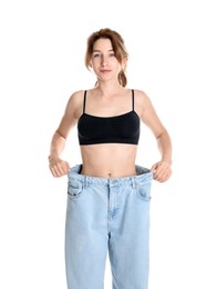 Woman in big jeans showing her slim body on white background