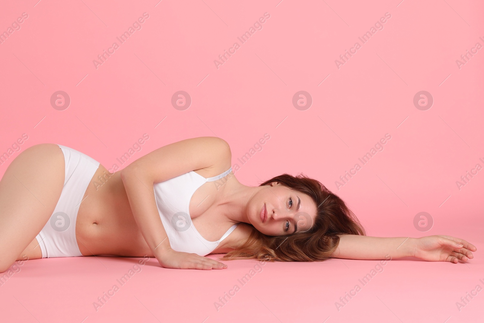 Photo of Woman with slim body posing on pink background