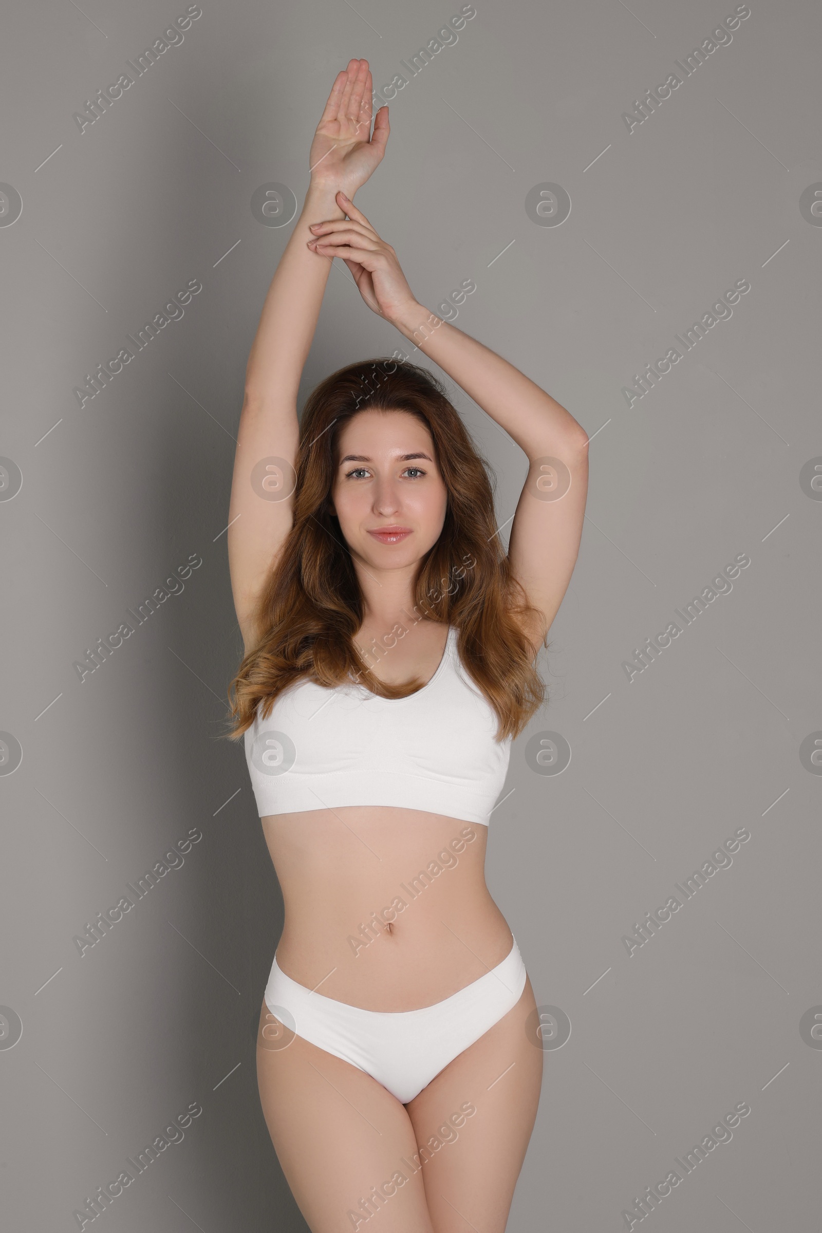 Photo of Woman with slim body posing on grey background
