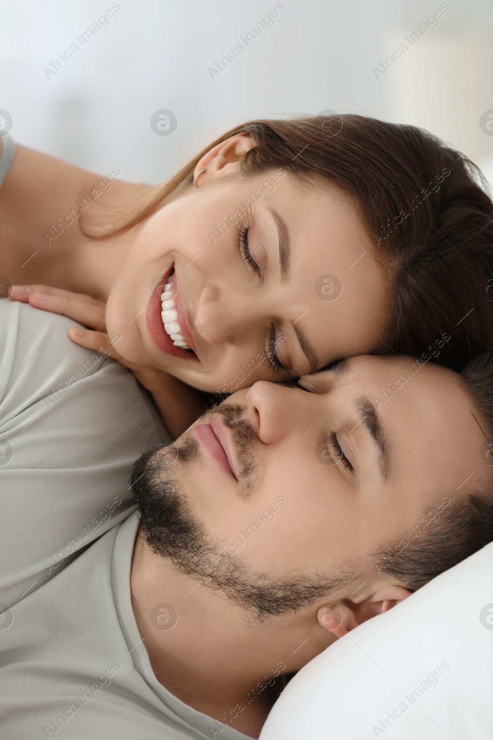 Photo of Lovely couple enjoying each other on bed at home