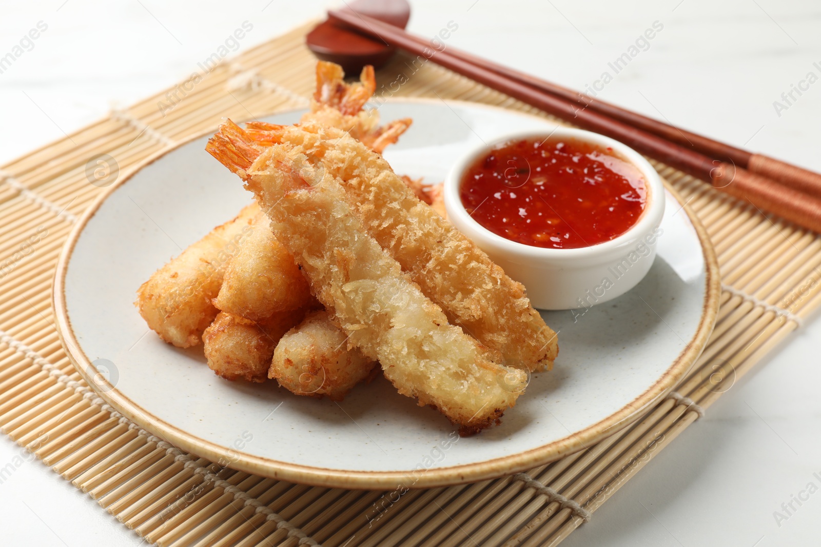 Photo of Delicious breaded fried shrimps served on white table