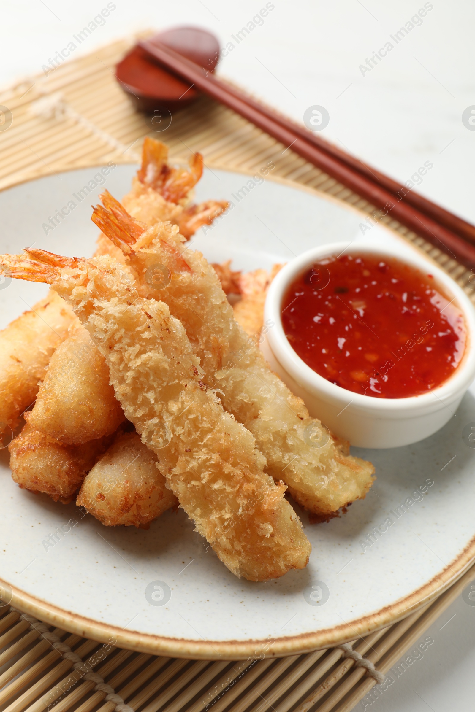 Photo of Delicious breaded fried shrimps served on white table