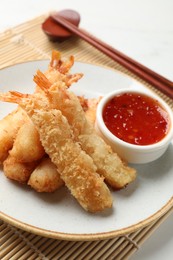 Photo of Delicious breaded fried shrimps served on white table