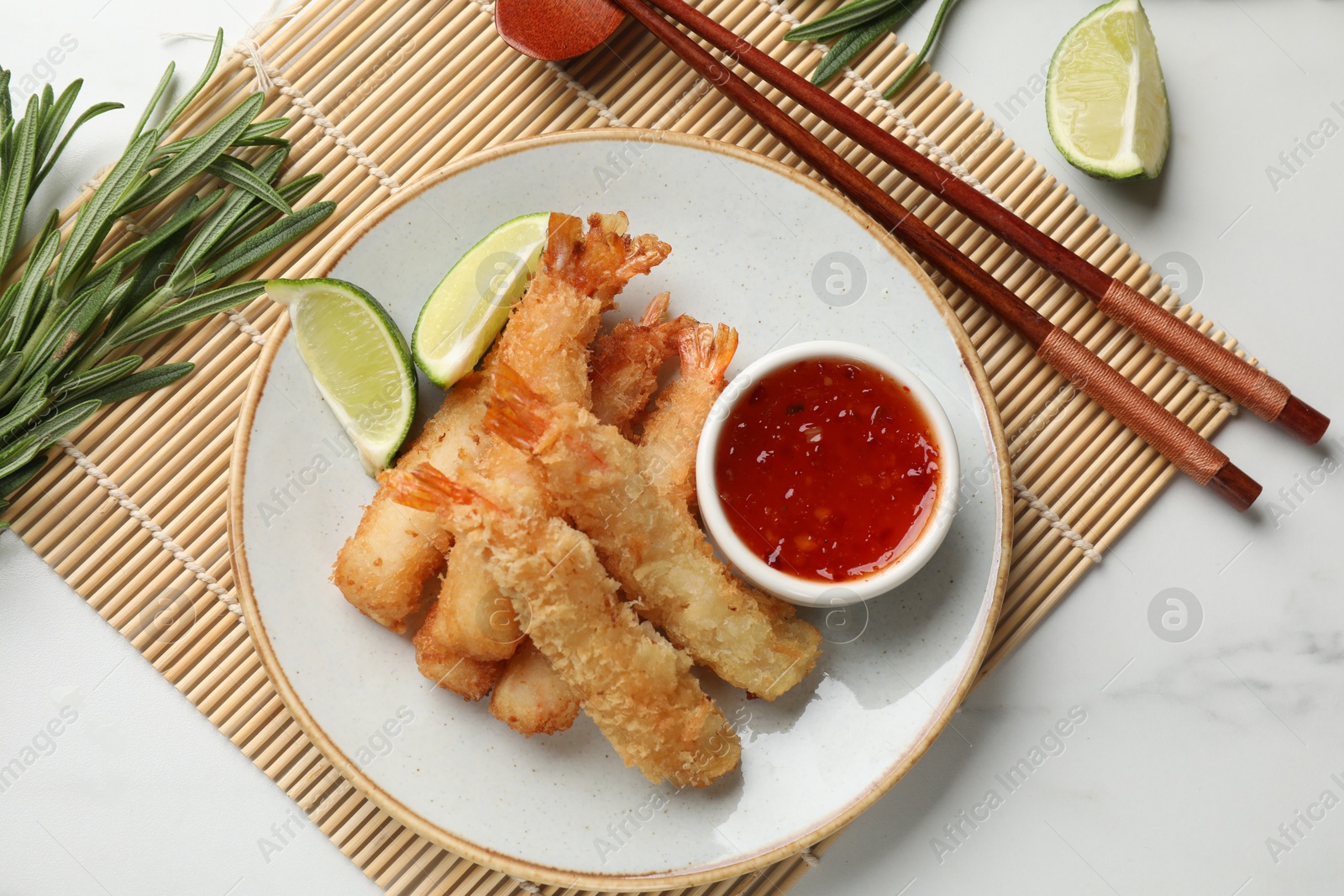 Photo of Delicious breaded fried shrimps served on white table, flat lay