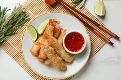 Delicious breaded fried shrimps served on white table, flat lay