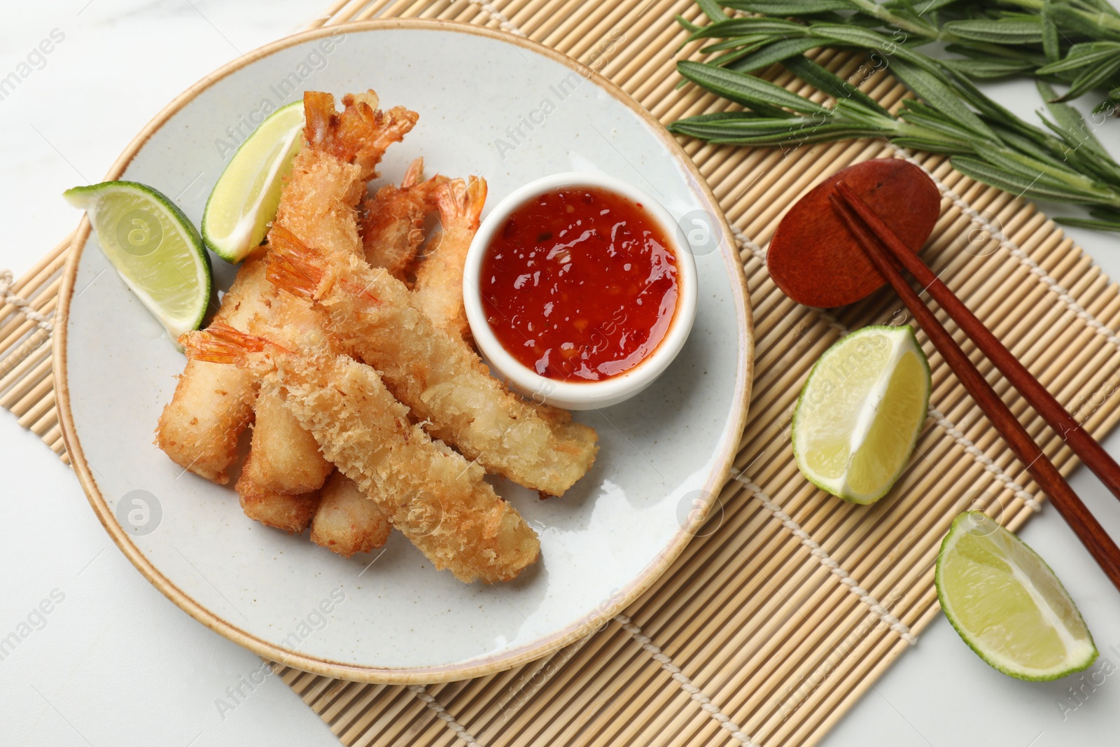 Photo of Delicious breaded fried shrimps served on white table, flat lay