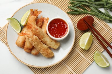 Delicious breaded fried shrimps served on white table, flat lay