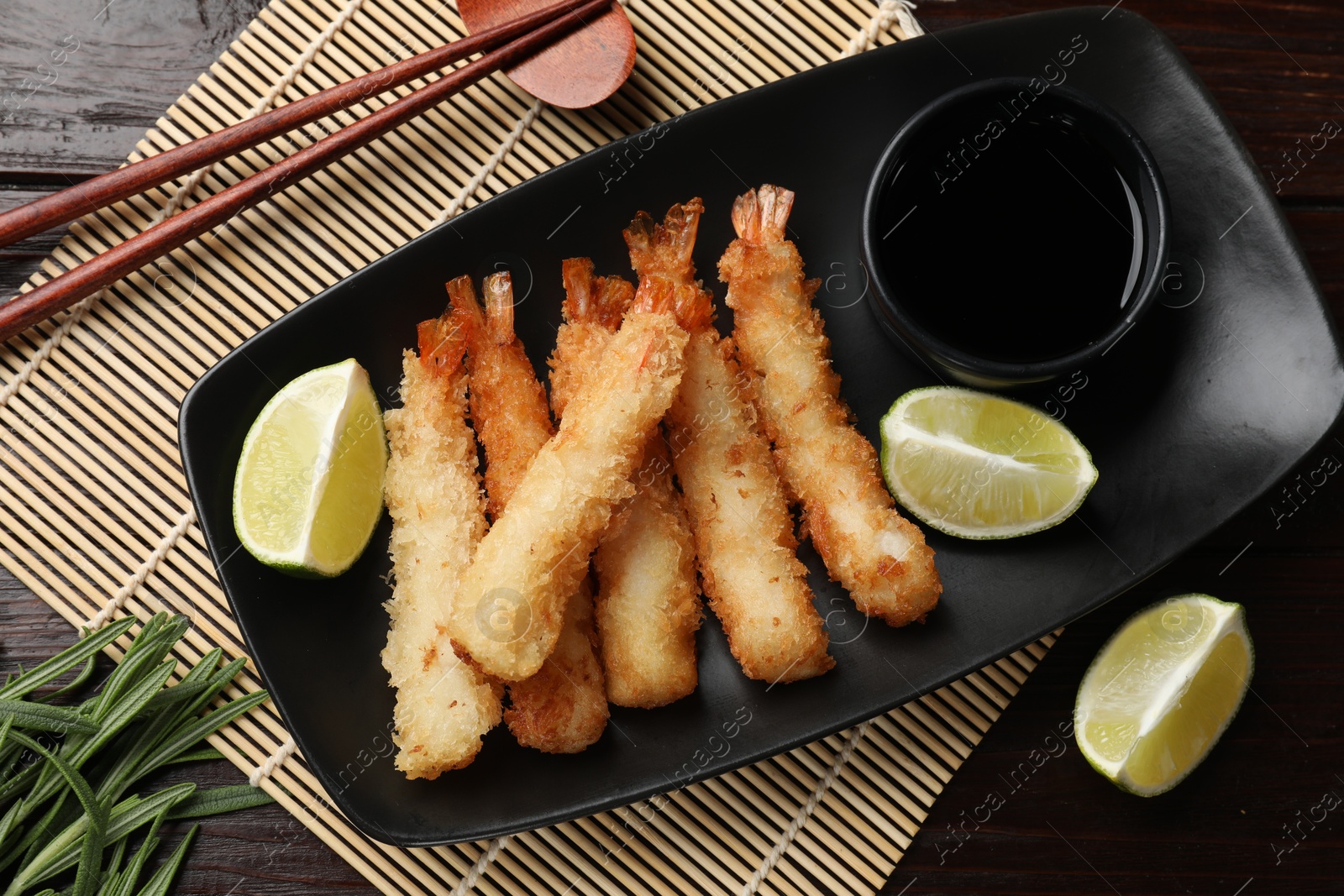 Photo of Delicious breaded fried shrimps served on wooden table