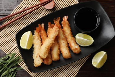 Delicious breaded fried shrimps served on wooden table