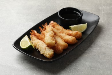 Delicious breaded fried shrimps served on grey table