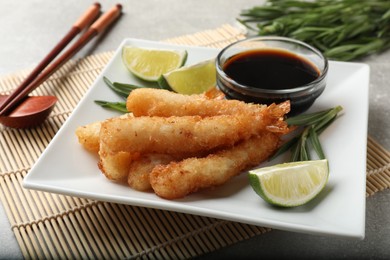 Delicious breaded fried shrimps served on grey table