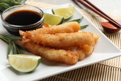 Photo of Delicious breaded fried shrimps served on table, closeup