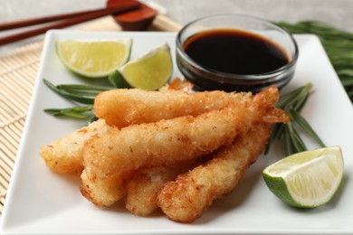 Photo of Delicious breaded fried shrimps served on table, closeup