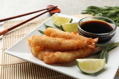 Delicious breaded fried shrimps served on table, closeup