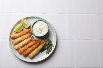 Delicious breaded fried shrimps served on white tiled table, top view. Space for text