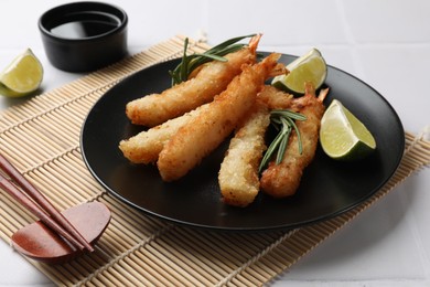 Photo of Delicious breaded fried shrimps served on white table