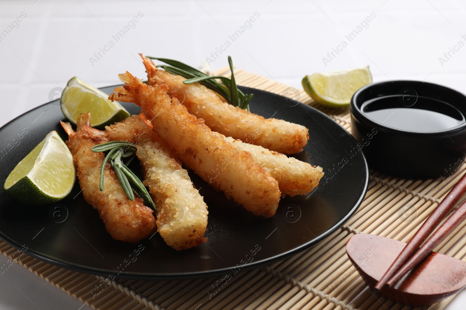 Photo of Delicious breaded fried shrimps served on white table