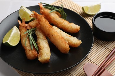 Delicious breaded fried shrimps served on white table, closeup