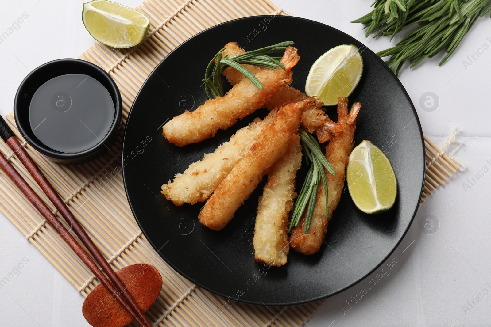 Photo of Delicious breaded fried shrimps served on white table, flat lay