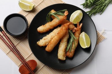 Delicious breaded fried shrimps served on white table, flat lay