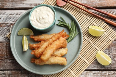 Delicious breaded fried shrimps served on wooden table, flat lay