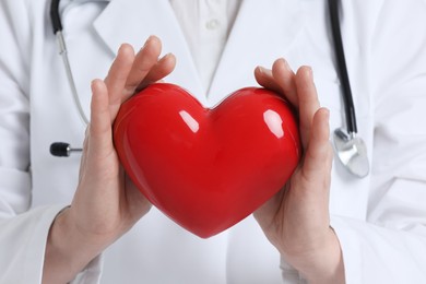 Doctor with stethoscope and red heart, closeup