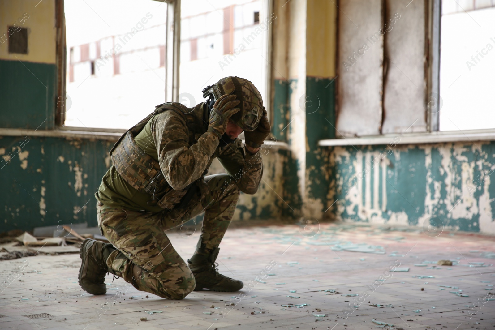 Photo of Military mission. Soldier in uniform inside abandoned building, space for text