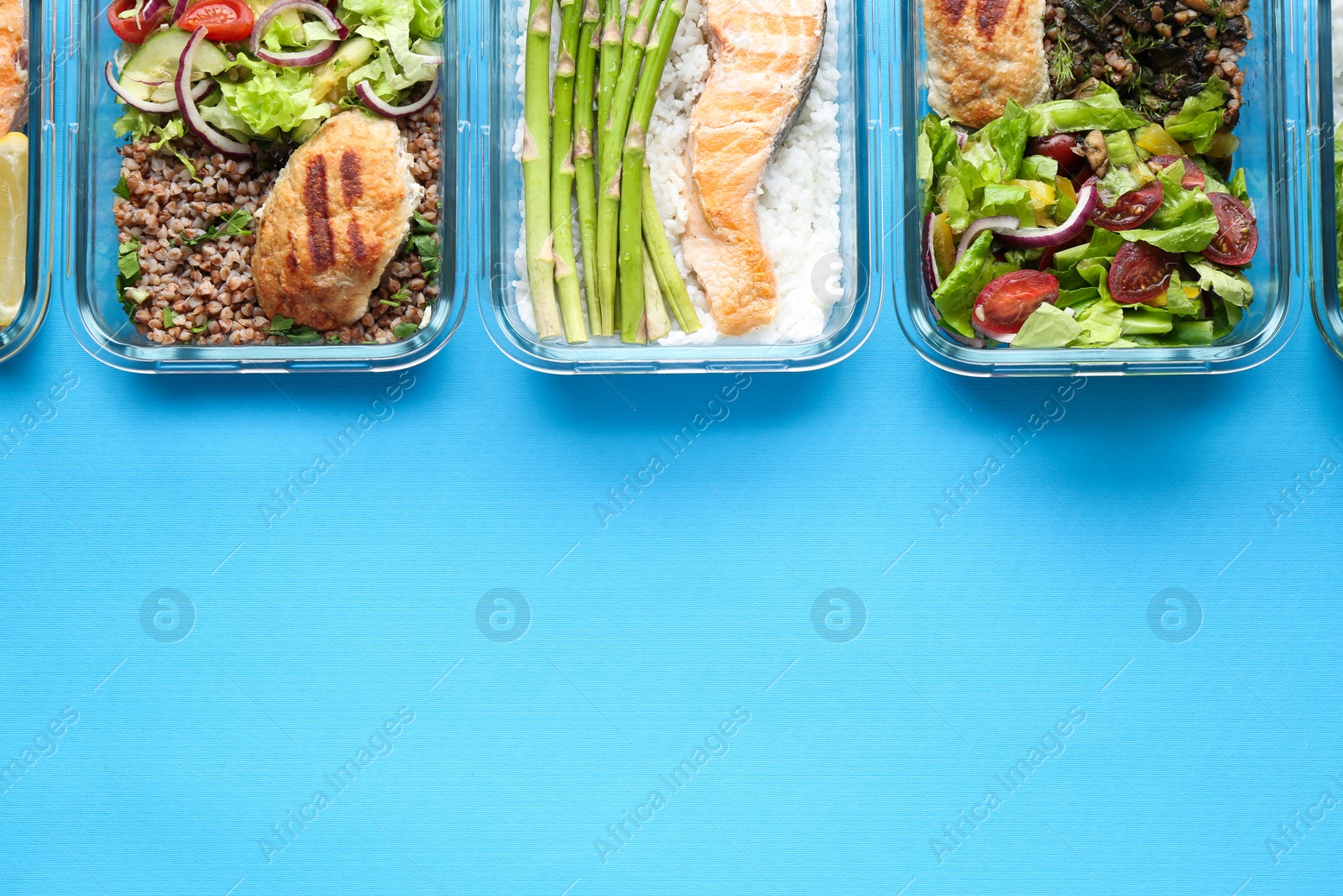 Photo of Healthy food. Different meals in glass containers on light blue background, flat lay. Space for text