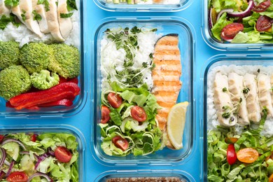 Healthy food. Different meals in glass containers on light blue background, flat lay