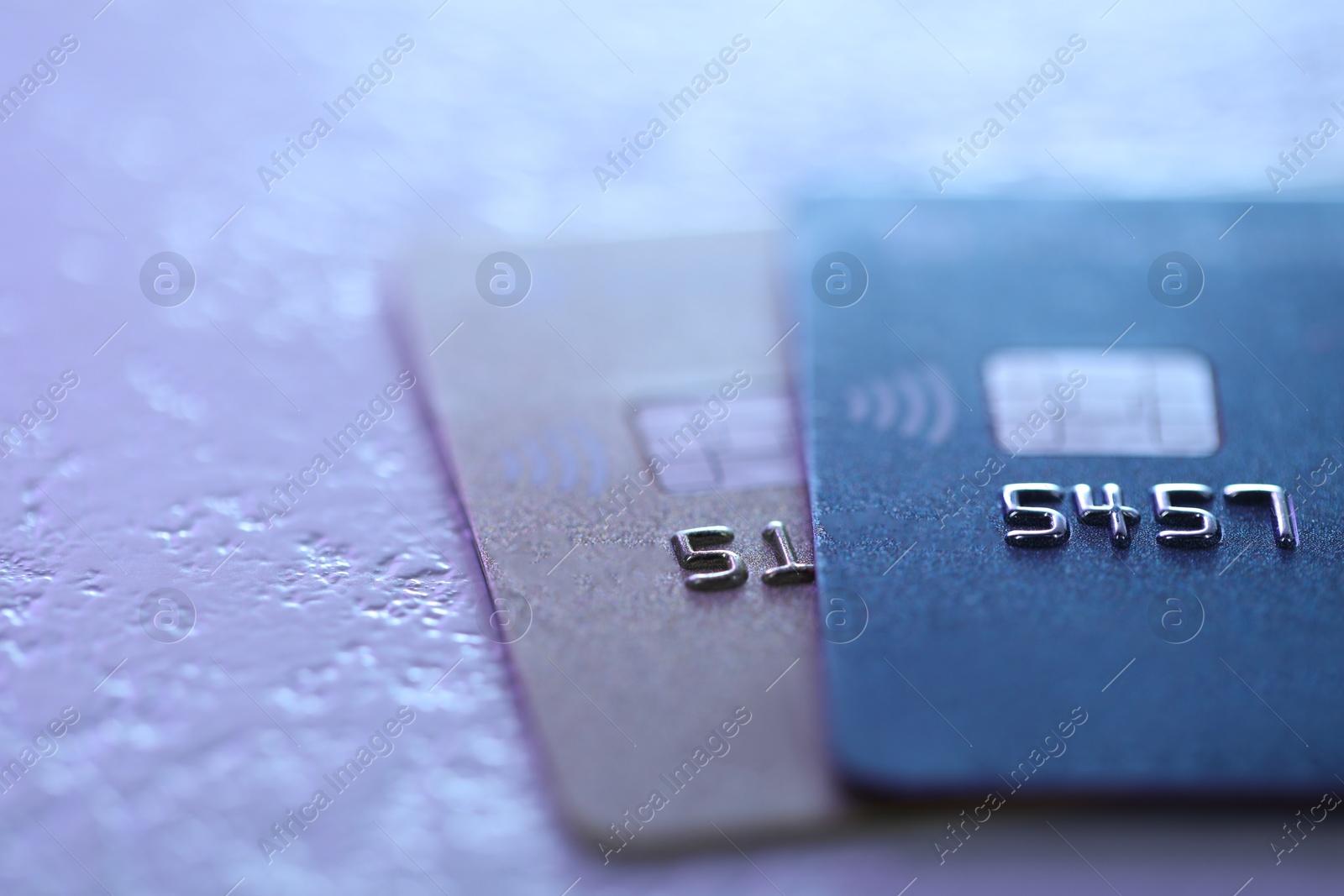 Photo of Plastic credit cards on table, closeup view. Color toned