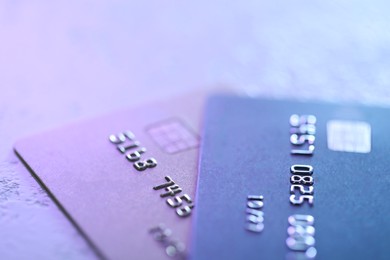 Photo of Plastic credit cards on table, closeup view. Color toned