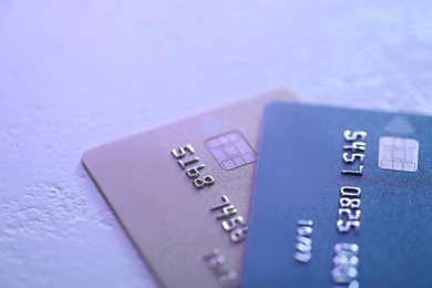 Photo of Plastic credit cards on table, closeup view. Color toned