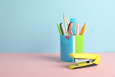 Photo of Stapler and other stationery on color background, space for text