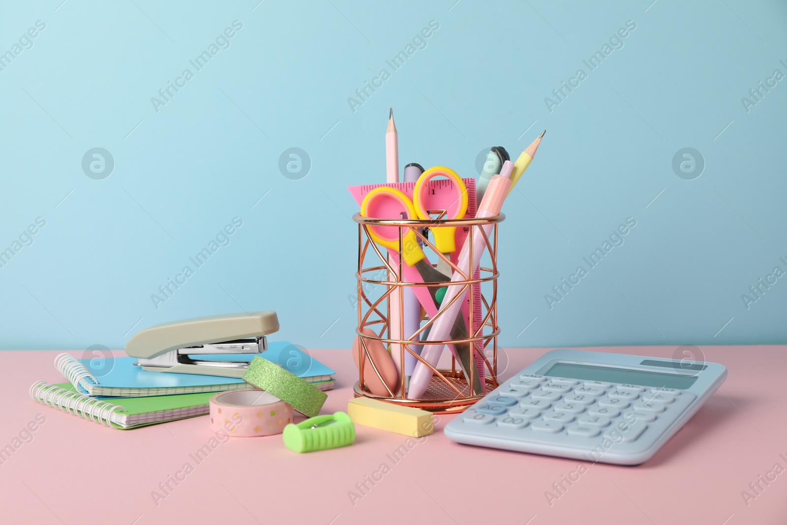 Photo of Stapler and other stationery on color background