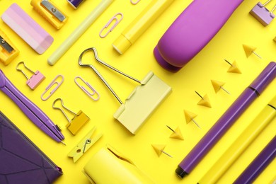 Photo of Flat lay composition with notebook, stapler and different stationery on yellow background