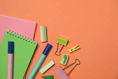 Photo of Flat lay composition with notebooks and different stationery on orange background, space for text