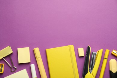 Flat lay composition with notebook, stapler and different stationery on violet background, space for text