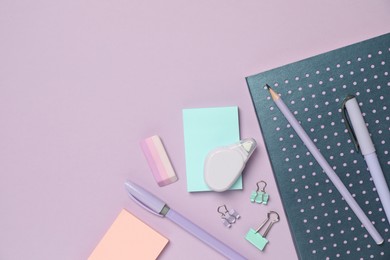 Photo of Flat lay composition with notebook and different stationery on violet background